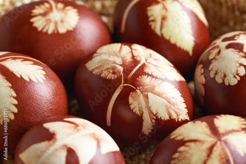 Fotografi Brown Easter eggs dyed with onion peels with a pattern of plant leaves