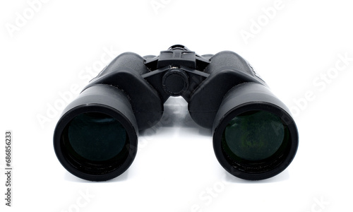A pair of black rubber grip metal binoculars isolated on white background. Well worn, used, dirty full of sand from being out in the field viewing wildlife. Back view