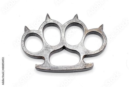 Old metal brass knuckles knuckledusters with spikes isolated on white background injuries, street fights, fights without rules, urban crime. German World War Two military era showing marks scrapes