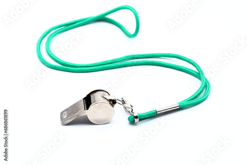 Whistle with green lace. White background. photo