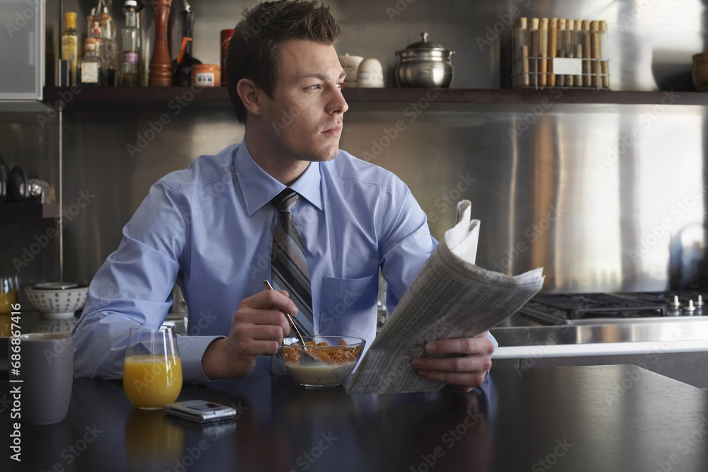 Man Reading Newspaper During Breakfast Man Reading Newspaper During Breakfast