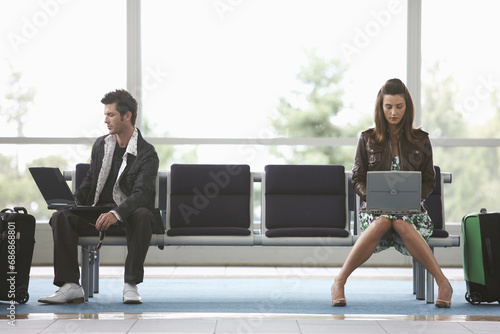 Man and Woman in Airport Waiting Area photo
