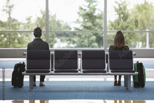 Man and Woman in Airport Waiting Area photo