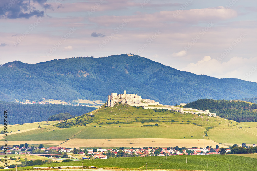Spiss castle (spissky hrad) in summer day, medieval ruin, unesco heritage, Slovakia, Europe. Slovakia summer landscape. Green summer fields, meadows, hills of Tatra mountain.