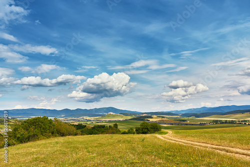 Obraz na płótnie Slovakia summer landscape. Green summer fields, meadows, hills of Tatra mountains. Travel in vacations. Rural Road in Spis region, Slovakia. Spissky hrad national park w salonie