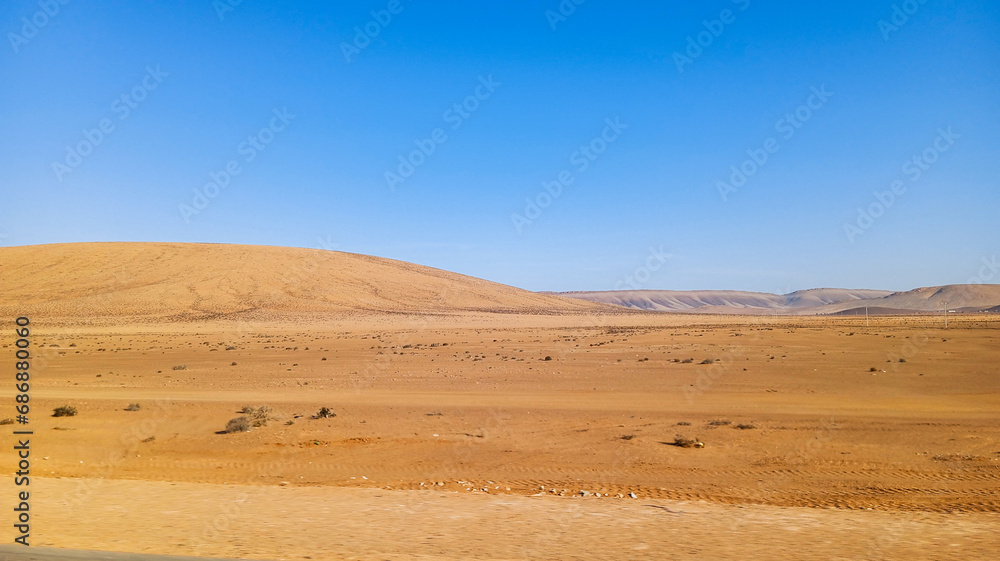 Beautiful natural view of moroccan desert landscape on sunny day with beautiful blue sky. Moroccan southern regions hills.