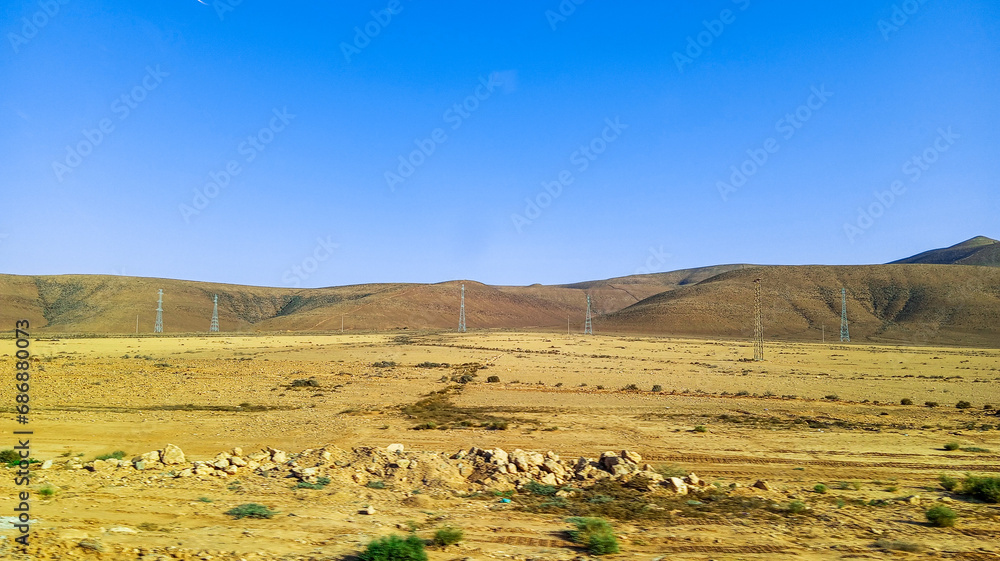 Beautiful natural view of moroccan desert landscape on sunny day with beautiful blue sky. Moroccan southern regions hills.