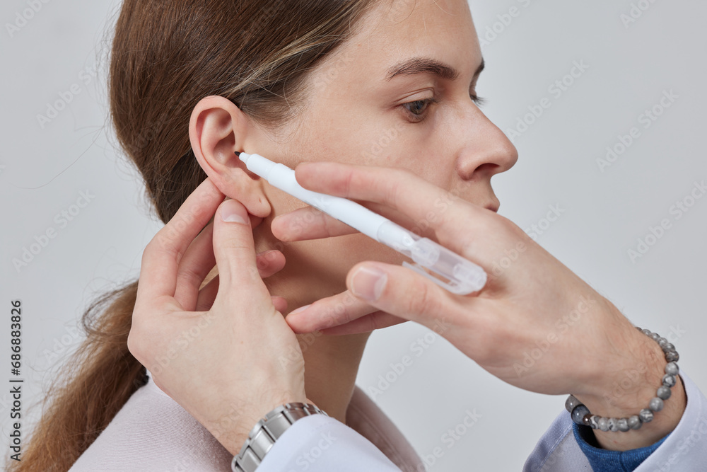 The doctor surgeon is preparing for the operation Otoplasty, Ear plastic surgery, correction of protruding ears The doctor surgeon is preparing for the operation Otoplasty, Ear plastic surgery, correction of protruding ears