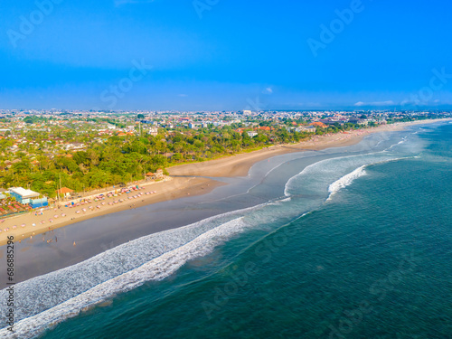 Aerial view of Seminyak beach coastline. The famous and luxury Kuta beach resort in southern Bali, Indonesia. Sunny day drone photo