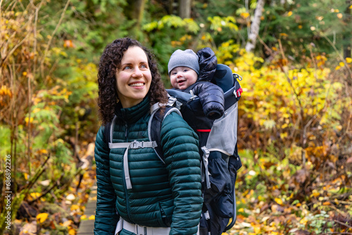 Mother Hiking with Baby in Backpack Carrier in Canadian Nature. © edb3_16