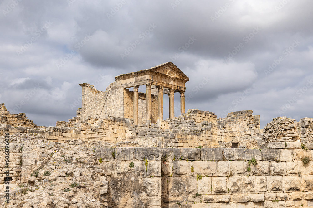 The Capitol Temple at the Roman ruins of Dougga, Tunisia. - obrazy, fototapety, plakaty 
