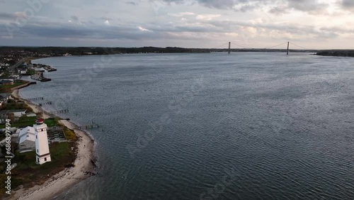 Aerial footage of Strib Lighthouse and bridge over Danish strait between island of Funen and Jutland. Beacon on the Danish coast and bridge Den Nye Lillebæltsbro (The New Little Belt Bridge). photo