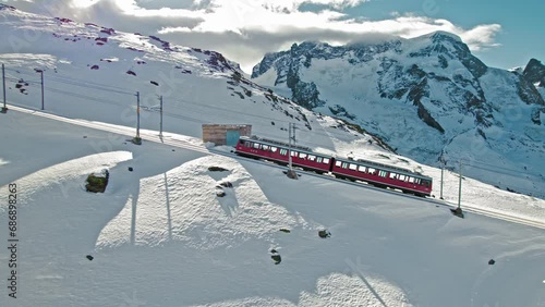 Aerial view of Swiss electrified cog railway train ride to the Gornergrat in Zermatt. View from above of the train with tourists in the Alps in Europe, Switzerland.