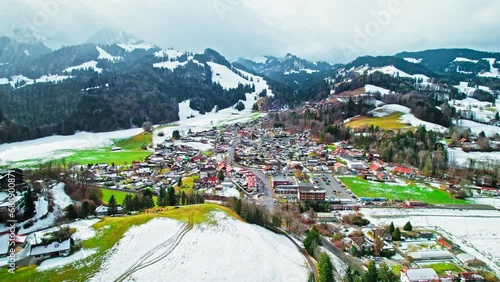 Aerial view of Swiss heritage site of national significance Gruyères Castle. View from above of hilltop fortress covered by snow in Switzerland. photo