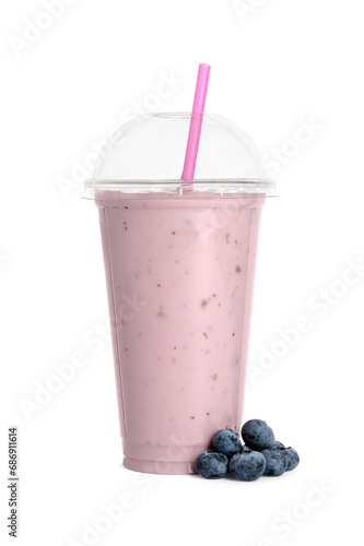 Plastic cup of tasty smoothie and fresh blueberries isolated on white
