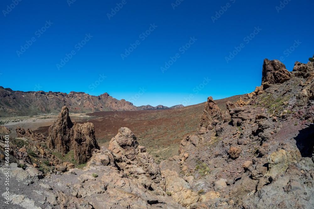 The lava fields of Las Canadas caldera of Teide volcano and rock formations - Roques de Garcia. Tenerife. Canary Islands. Spain. The lava fields of Las Canadas caldera of Teide volcano and rock formations - Roques de Garcia. Tenerife. Canary Islands. Spain.