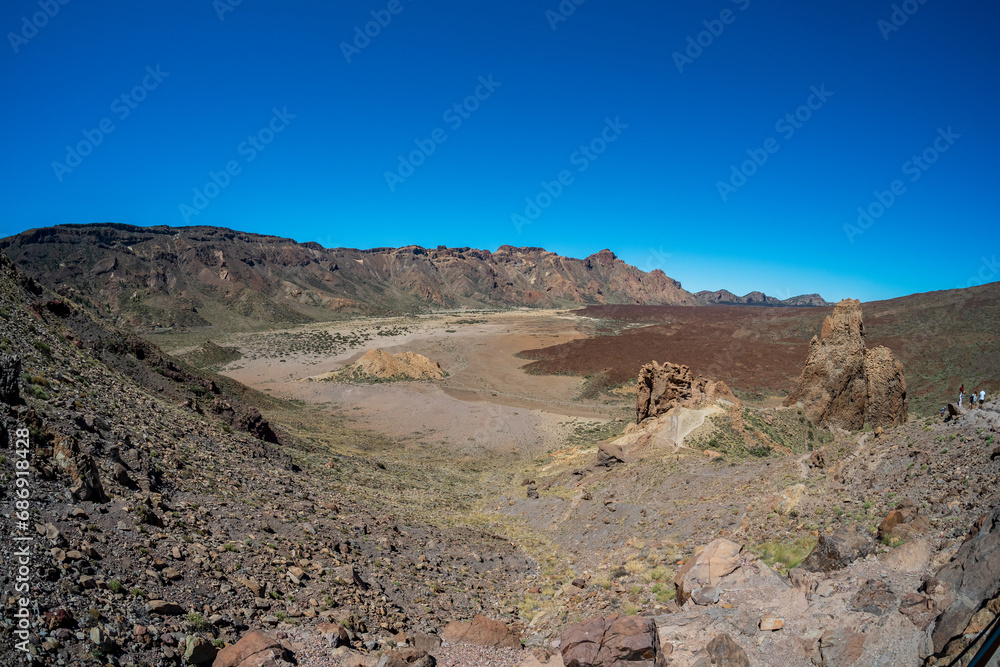 The lava fields of Las Canadas caldera of Teide volcano and rock formations - Roques de Garcia. Tenerife. Canary Islands. Spain.