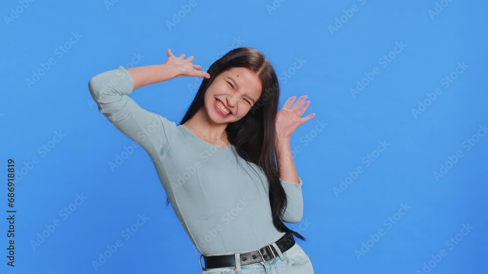 Funny comical playful young woman making silly facial expressions and grimacing, fooling around, showing tongue, idiotic expression. Girl isolated alone on blue studio background. People lifestyles Funny comical playful young woman making silly facial expressions and grimacing, fooling around, showing tongue, idiotic expression. Girl isolated alone on blue studio background. People lifestyles