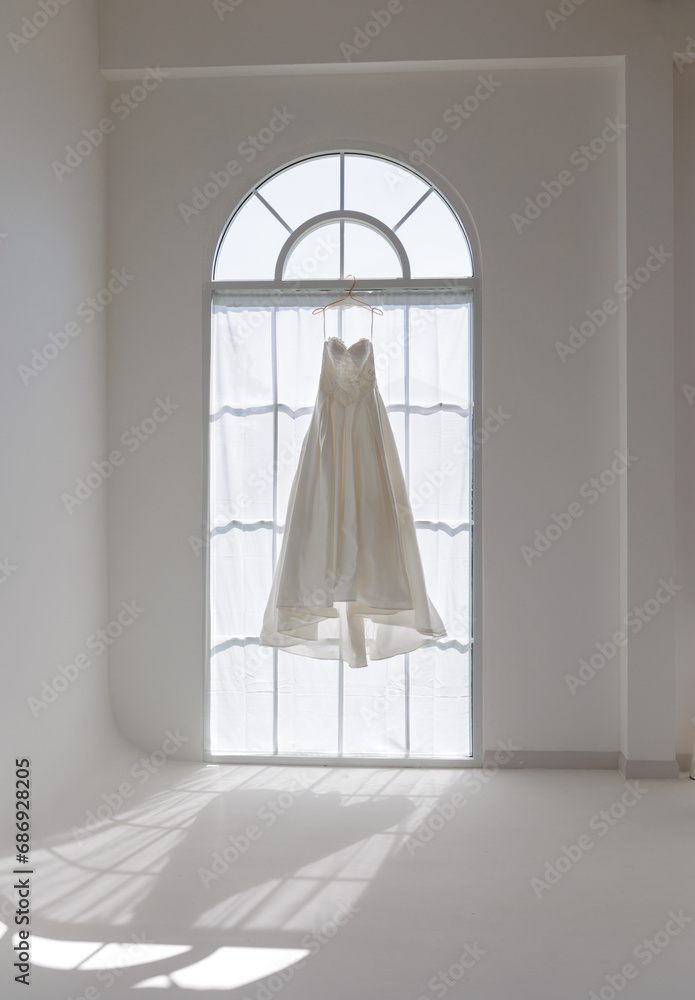 Ethereal Wedding Dress Floating in Sun Drenched Ceremony Room