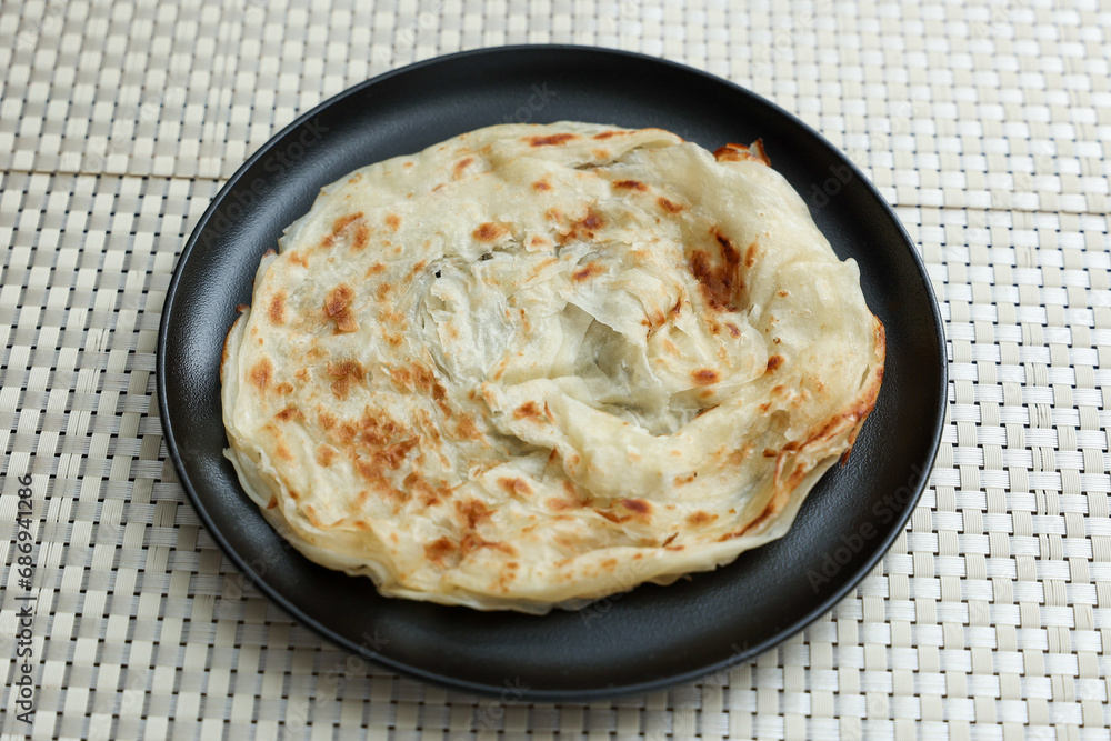 Kerala parathas / porotta / roti / parotta / barotta/ naan layered flatbread made from maida or whole wheat flour. Eat with spicy Asian chicken or beef or egg curry gravy. breakfast dish. Indian food. Kerala parathas / porotta / roti / parotta / barotta/ naan layered flatbread made from maida or whole wheat flour. Eat with spicy Asian chicken or beef or egg curry gravy. breakfast dish. Indian food.