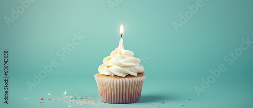 Birthday cupcake with cream and a burning candle