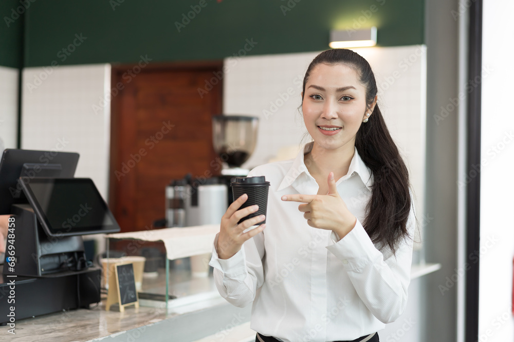 Portrait of barista cafe working at coffee shop standing with coffee cup with happy and smile. Small business and start up concept