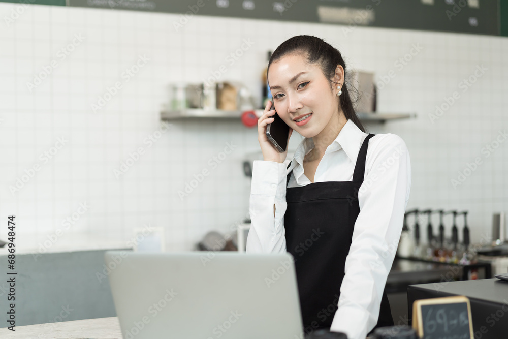 Barista cafe working at coffee shop and taking order from mobile for customer with happy and smile. Small business and start up concept Barista cafe working at coffee shop and taking order from mobile for customer with happy and smile. Small business and start up concept