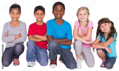Digital png photo of happy diverse children kneeling and smiling on transparent background