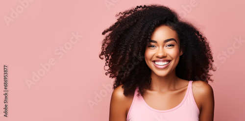 Portrait of a young smiling black woman. Skin care beauty, skincare cosmetics, dental concept, isolated over pink background. 