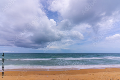 Beautiful sea beach background,Amazing sea ocean in good weather day,Beautiful waves crashing on sandy shore Nature beach sand background © panya99