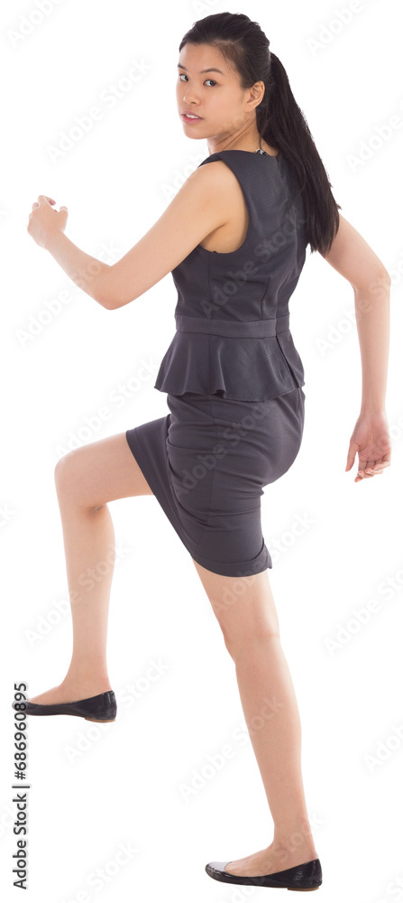 Digital png photo of serious asian businesswoman walking stairs on transparent background Digital png photo of serious asian businesswoman walking stairs on transparent background