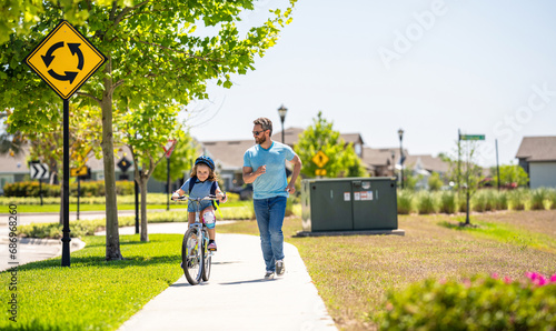 dad and son on biking adventure. dad and son duo pedaling through picturesque landscape. supportive dad guiding his son first bike ride. dad and son enjoying fun bike outing. Creating family memories