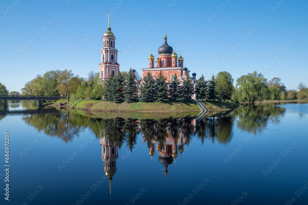 The ancient Cathedral of the Resurrection of Christ with a reflection in the May landscape on a sunny day. Staraya Russa, Russia