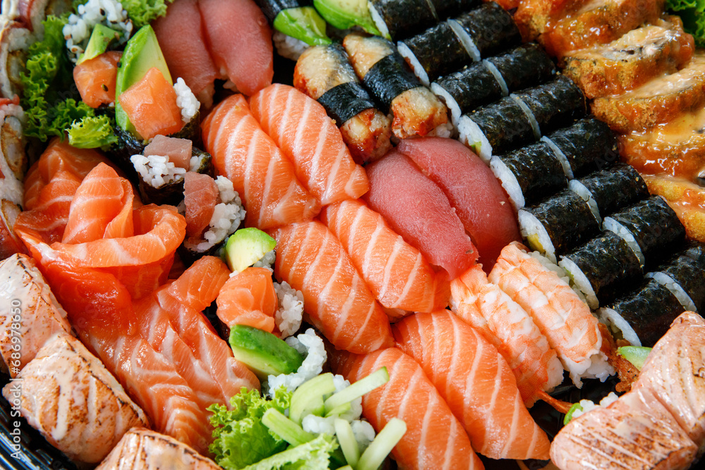 Assorted Sushi Nigiri and Maki Big Set on Slate. A Variety of Japanese Sushi with Tuna, Crab, Salmon, Eel, and Rolls. Top View. Assorted Sushi Nigiri and Maki Big Set on Slate. A Variety of Japanese Sushi with Tuna, Crab, Salmon, Eel, and Rolls. Top View.