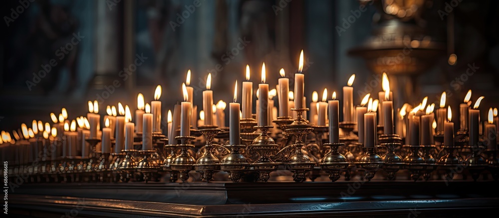 Lit candles on a church candelabrum creating a peaceful ambiance for prayer and meditation.