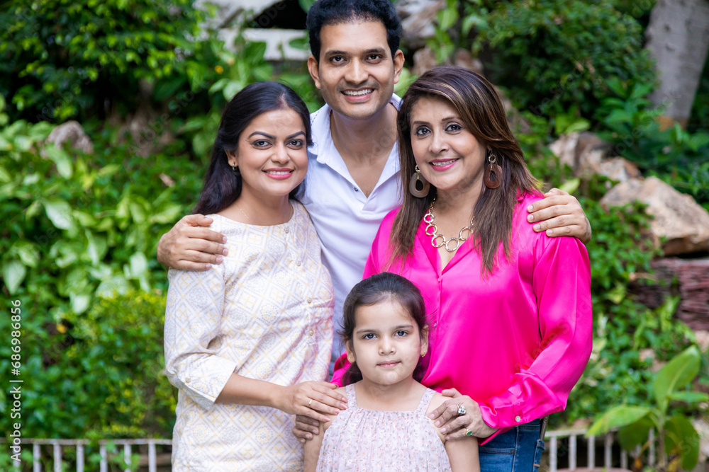 Portrait of happy Indian family standing together. Husband wife cute little daughter and mother. Portrait of happy Indian family standing together. Husband wife cute little daughter and mother.