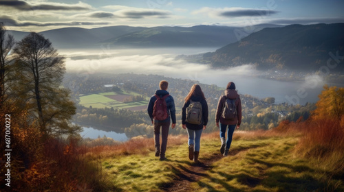 Digital composite of Couple walking on hill with fog and lake in background © red_orange_stock