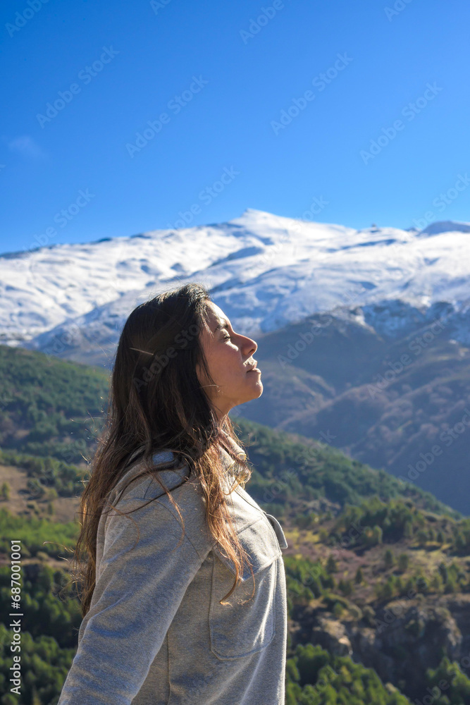 latina woman,long hair,breathing fresh air at the top of the mountain