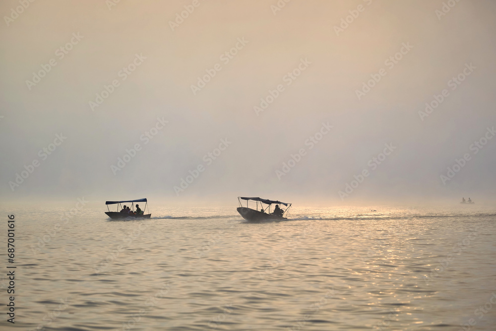 Scenic view of boat on river with  vapor in morning