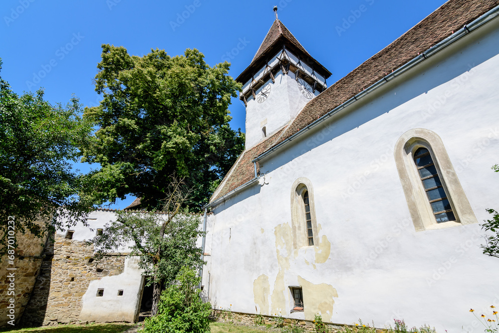Old building of Saints Peter and Paul fortified Church (Biserica Sfintii Apostoli Petru și Pavel) in Cincosr village, near Fagaras in Transylvania (Transilvania) region, Romania, in a sunny summer day Old building of Saints Peter and Paul fortified Church (Biserica Sfintii Apostoli Petru și Pavel) in Cincosr village, near Fagaras in Transylvania (Transilvania) region, Romania, in a sunny summer day