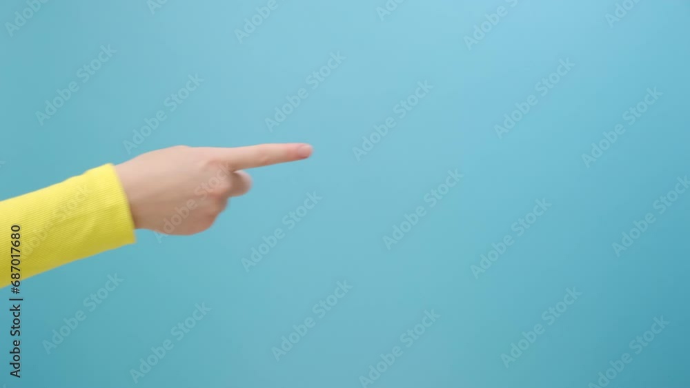 Close up of woman hand pointing on copy space for design, isolated on blue color background wall in studio. Advertisement place for text image promotional content Advertising area workspace mock up Close up of woman hand pointing on copy space for design, isolated on blue color background wall in studio. Advertisement place for text image promotional content Advertising area workspace mock up