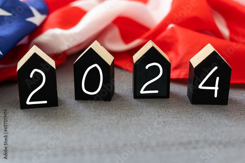 United States presidential election 2024. Wooden cubes with the letters 2024 on the American flag background. Politics and voting conceptual photo