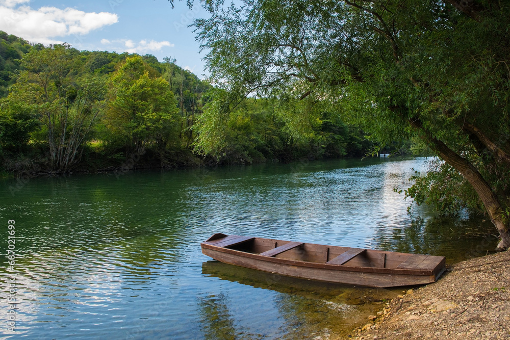 A wooden boat on the River Una north of Martin Brod, Bihac, in the Una National Park. Una-Sana Canton, Federation of Bosnia and Herzegovina. Early September A wooden boat on the River Una north of Martin Brod, Bihac, in the Una National Park. Una-Sana Canton, Federation of Bosnia and Herzegovina. Early September