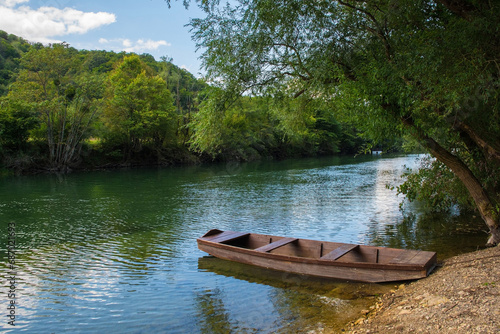 A wooden boat on the River Una north of Martin Brod, Bihac, in the Una National Park. Una-Sana Canton, Federation of Bosnia and Herzegovina. Early September © dragoncello