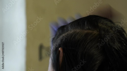 Brunette woman applying hair dye, hair coloring
