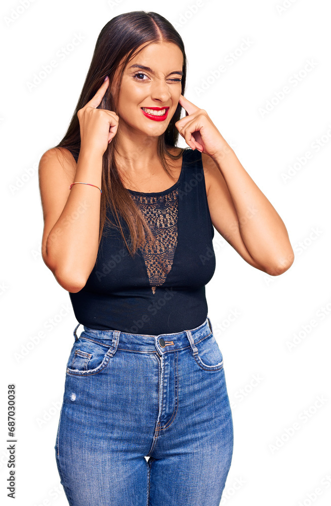 Young hispanic woman wearing casual clothes covering ears with fingers with annoyed expression for the noise of loud music. deaf concept. Young hispanic woman wearing casual clothes covering ears with fingers with annoyed expression for the noise of loud music. deaf concept.
