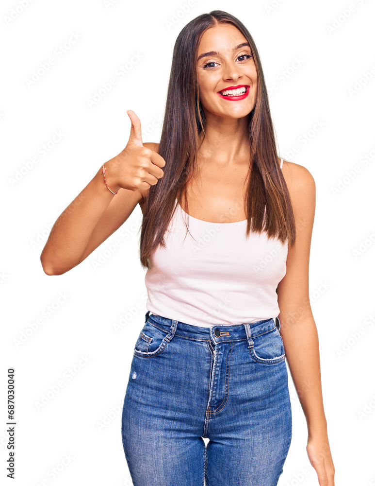 Young hispanic woman wearing casual clothes smiling happy and positive, thumb up doing excellent and approval sign Young hispanic woman wearing casual clothes smiling happy and positive, thumb up doing excellent and approval sign