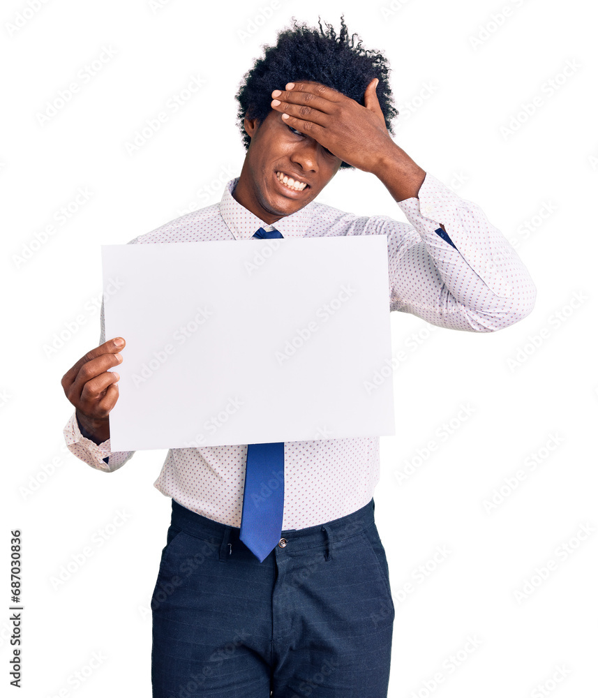 Handsome african american man with afro hair holding blank empty banner stressed and frustrated with hand on head, surprised and angry face Handsome african american man with afro hair holding blank empty banner stressed and frustrated with hand on head, surprised and angry face