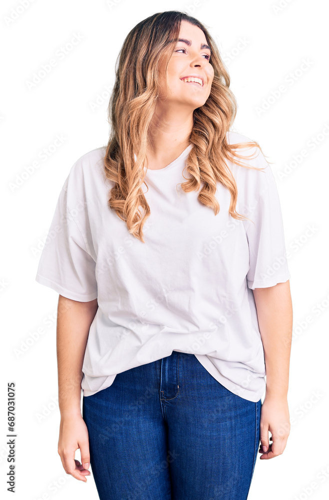 Young caucasian woman wearing casual clothes looking away to side with smile on face, natural expression. laughing confident. Young caucasian woman wearing casual clothes looking away to side with smile on face, natural expression. laughing confident.