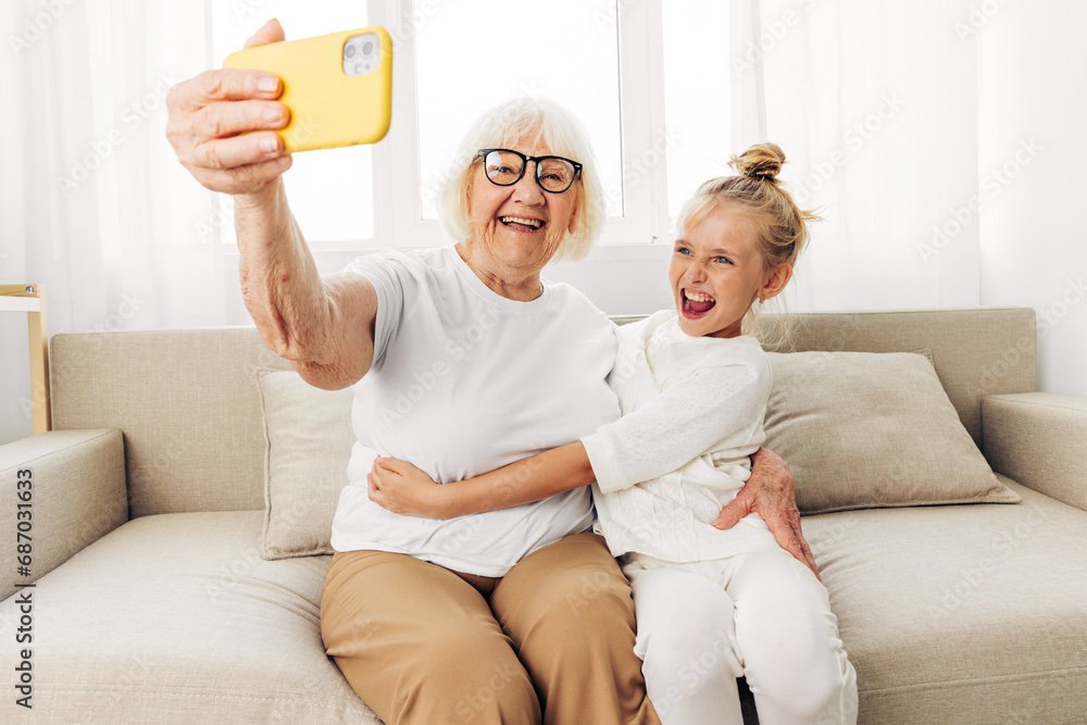 Granddaughter grandmother bonding selfie phone child smiling family hugging togetherness